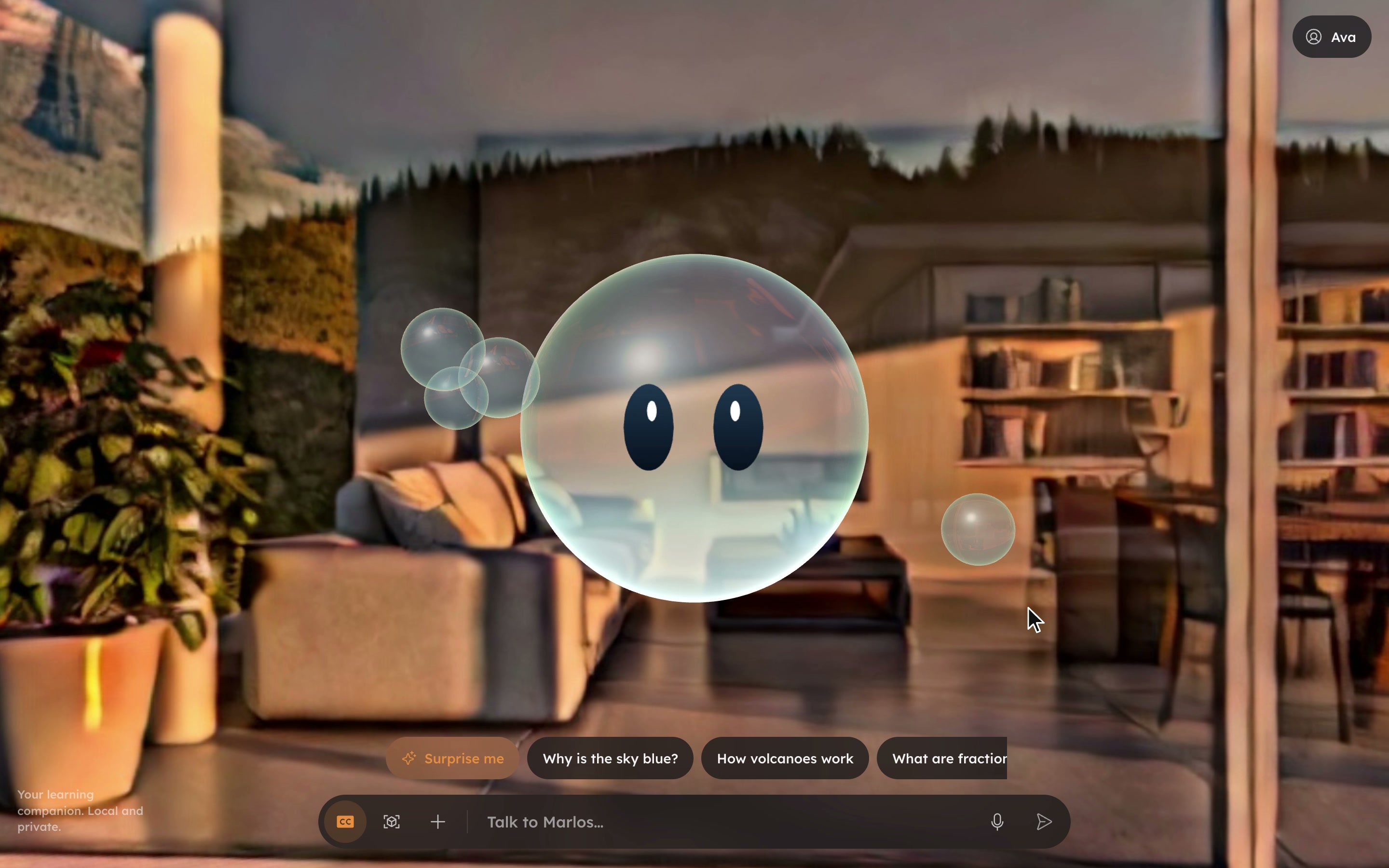 Still of the Marlos companion: Marlos, a glass bubble with two dark eyes and small satellite bubbles, floats in a warm living room. Below him are suggestion chips such as Why is the sky blue? and How volcanoes work, and a bar that reads Talk to Marlos.