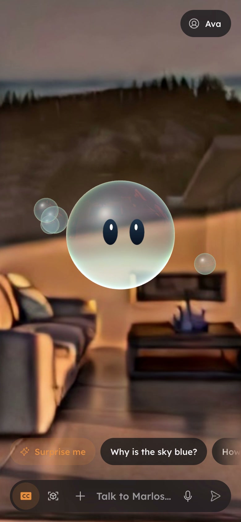 Still of the Marlos companion on a phone: Marlos, a glass bubble with two dark eyes, floats in a warm living room above suggestion chips and a bar that reads Talk to Marlos.