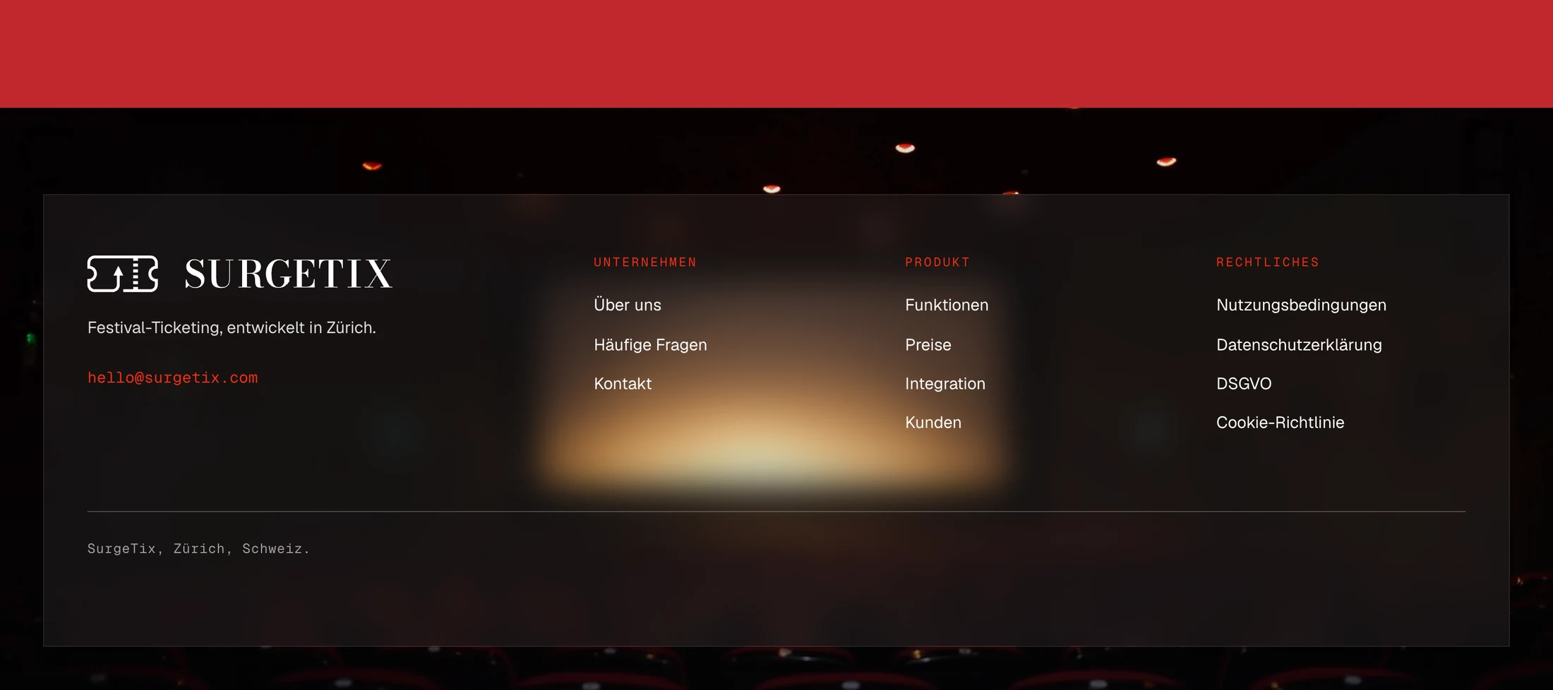 The foot of the site: a dark panel over a dim cinema hall with a warm glow, the logo with a line of text and an address in red, and three columns of links under red headings.