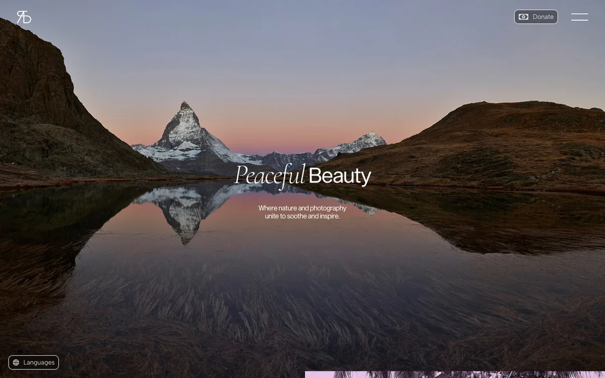 The second screen of the home page: a photograph of a pointed snow covered mountain mirrored in a still lake at dusk, with the words Peaceful Beauty, the first in serif italics, and the line Where nature and photography unite to soothe and inspire.
