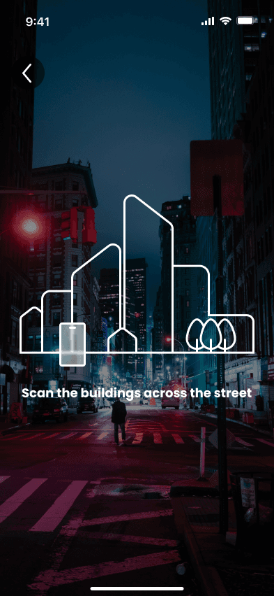 AR camera view of a city street at night with red lights. A white line drawing of buildings and a phone lies over it, with the instruction Scan the buildings across the street.