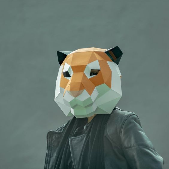 Moodboard picture: a person in a leather jacket wears a low poly tiger mask in orange, white and pale green.