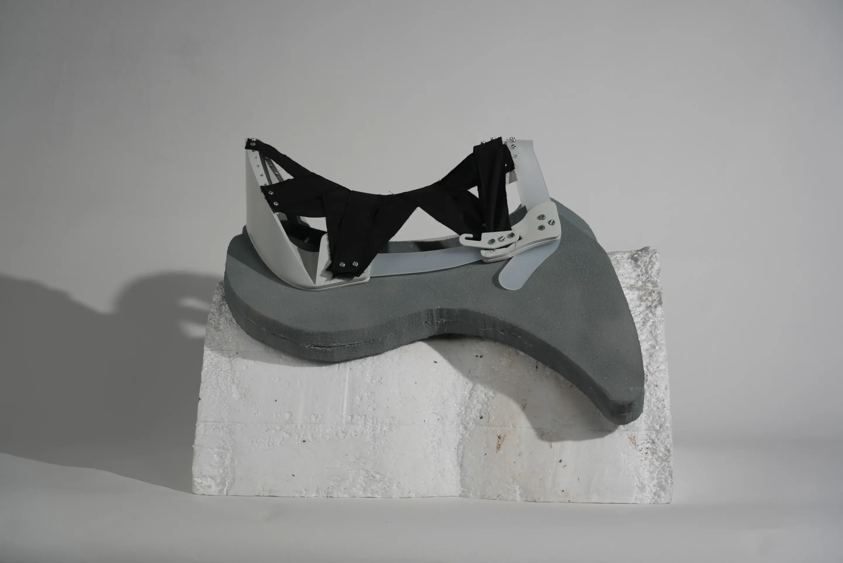 Prototype step: the tree with the black seat web sits on a grey pad that hangs over the side of the foam block.