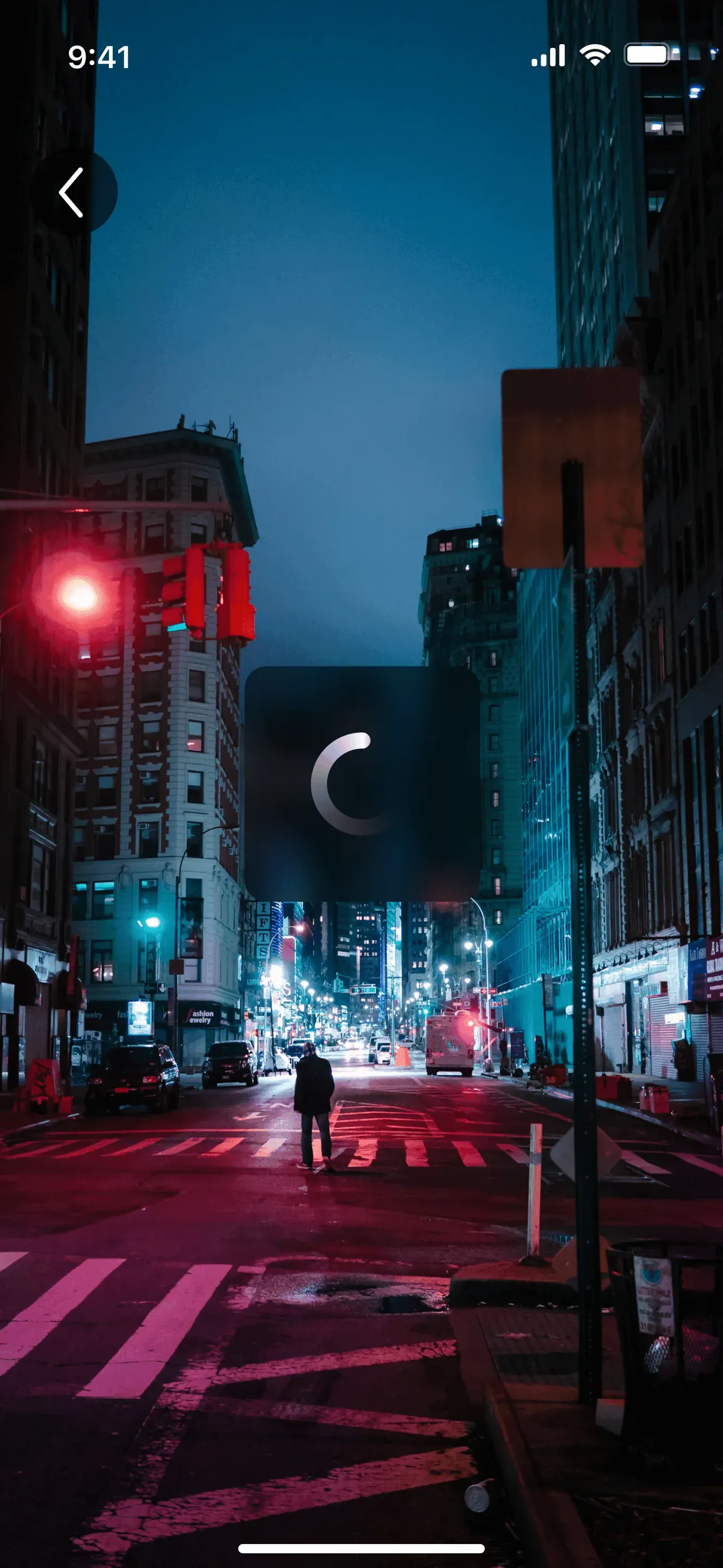 AR camera view of the night street with a dark square in the middle that shows a loading spinner.