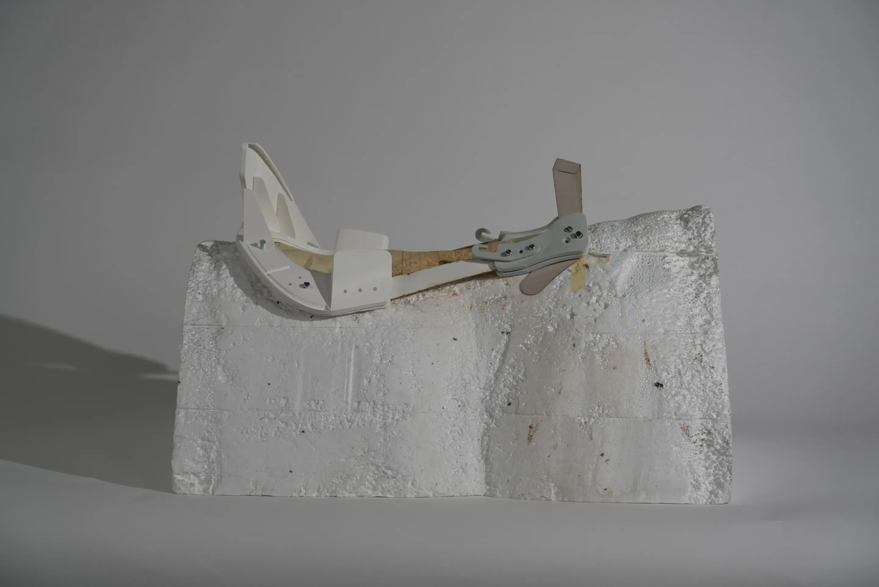 Prototype step: a white printed tree with a card cantle and perforated brackets on the foam block.