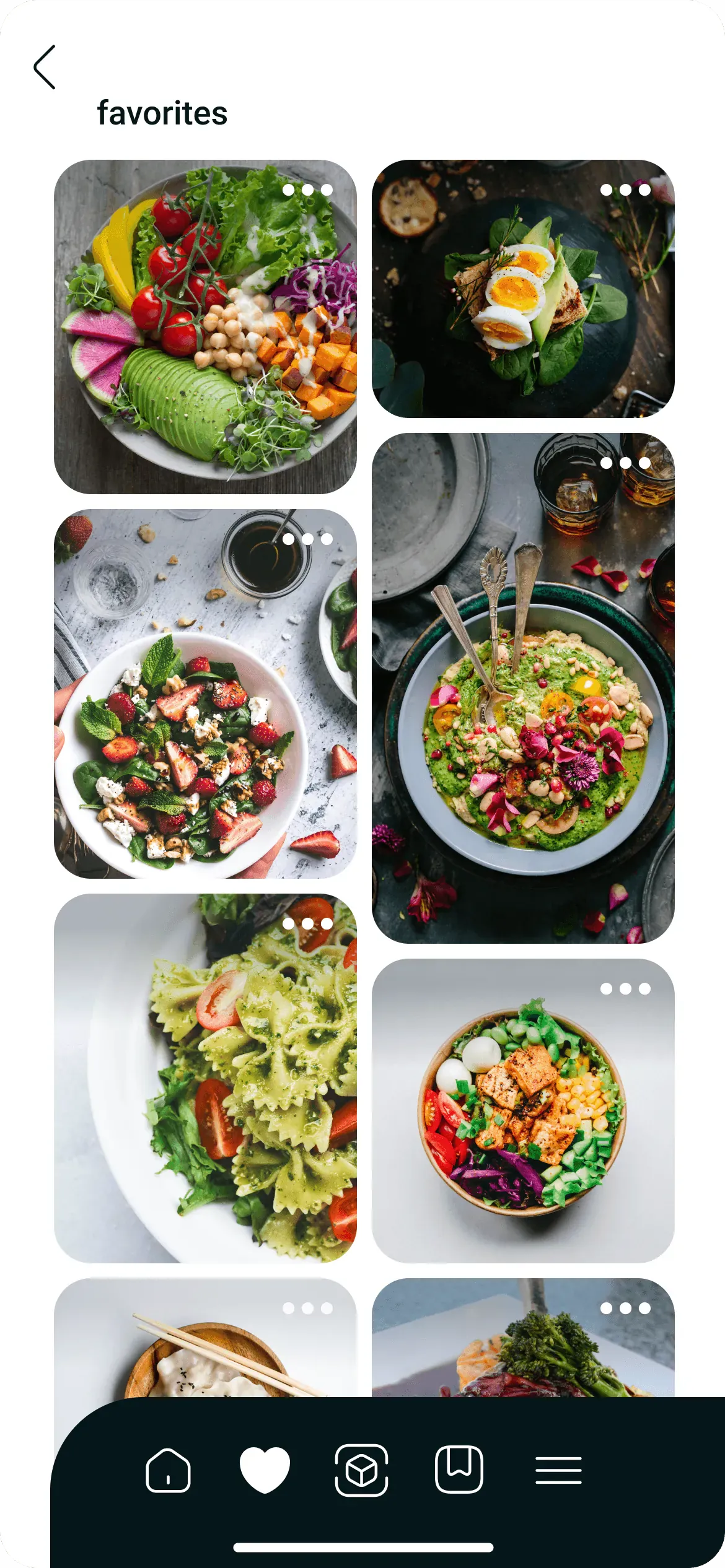 Favorites screen: two columns of food photos with rounded corners, salads and bowls seen from above. In the tab bar the heart icon is filled.