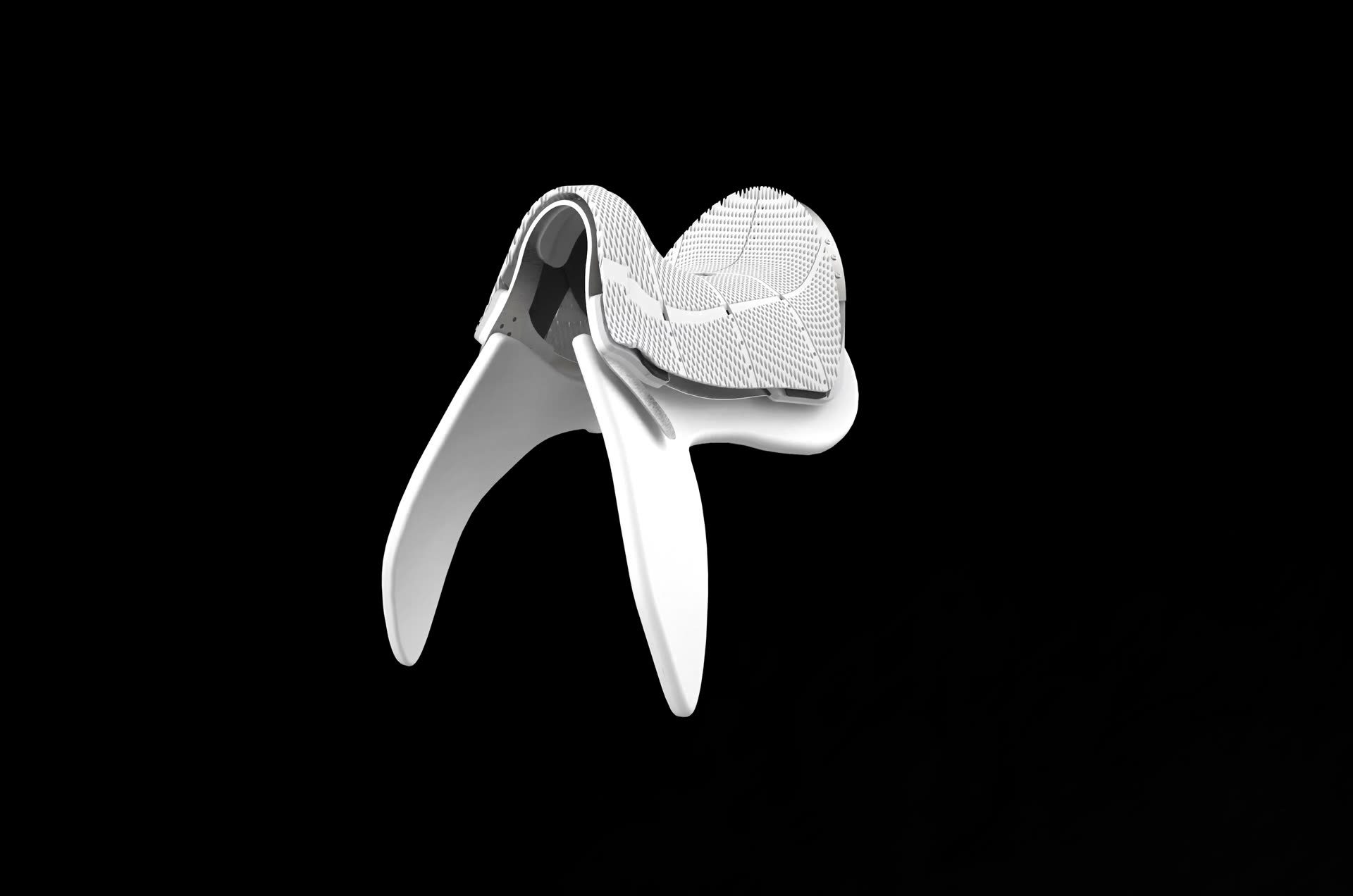 Still of the film loop: a white saddle tree with a perforated seat pad on a black ground.
