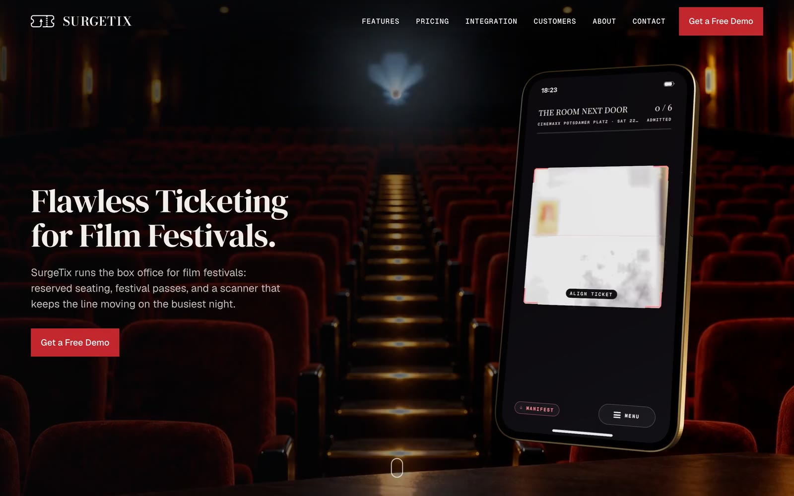 The SurgeTix home page: the headline Flawless Ticketing for Film Festivals and a red button on the left, a phone with a scanner app on the right, over rows of red cinema seats.