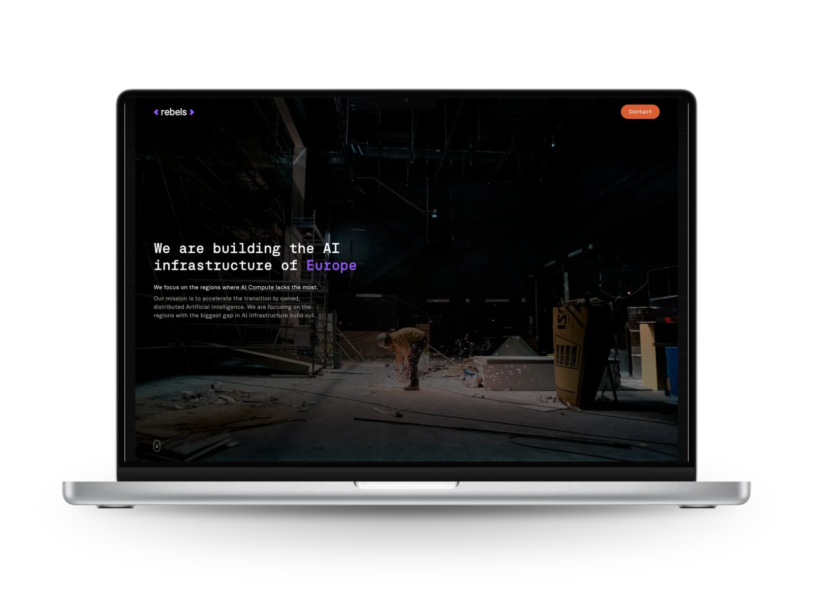 Rebels: the home page of the website on a laptop, a dark hall and the line We are building the AI infrastructure of Europe.